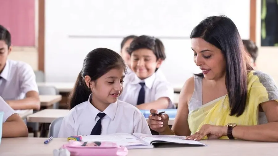 Teacher assisting student in classroom